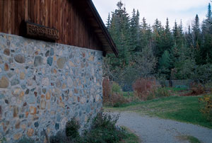 A stone shed that the Nearings built by hand flanks the entrance to Forest Farm.